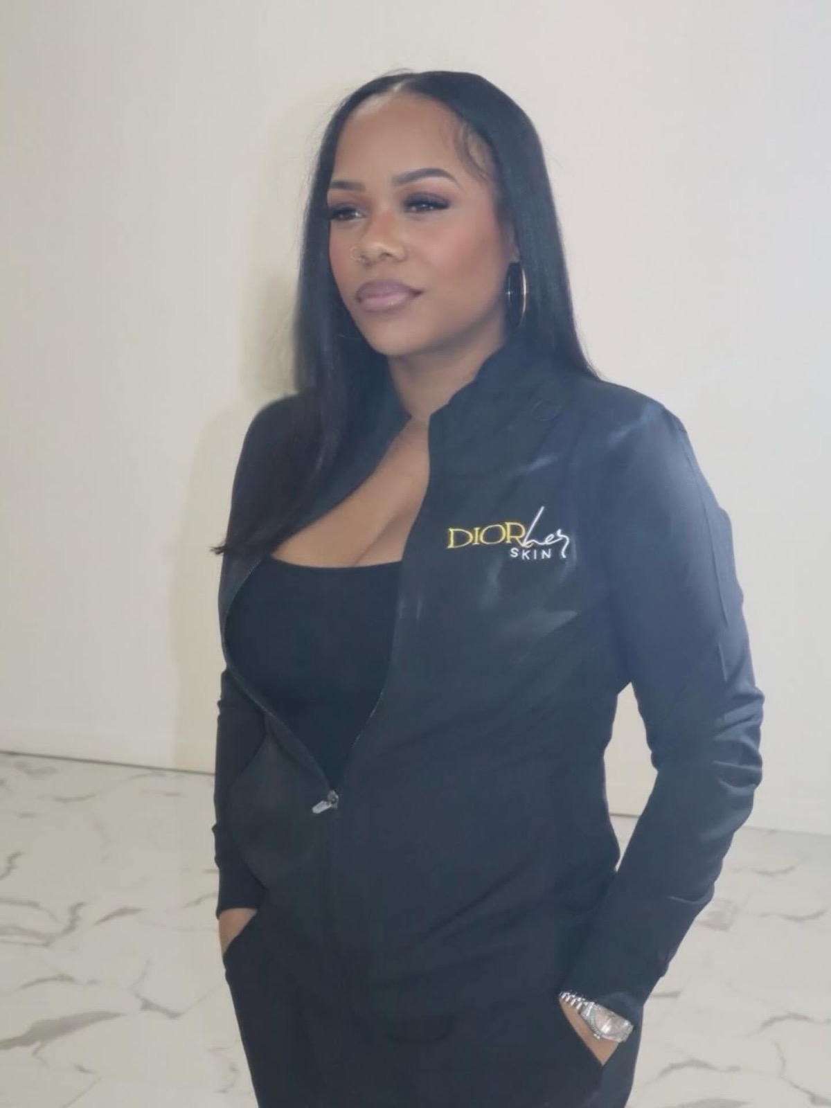 Kri Pitre, licensed esthetician and founder of DIORherSkin, in a branded DIORherSkin jacket